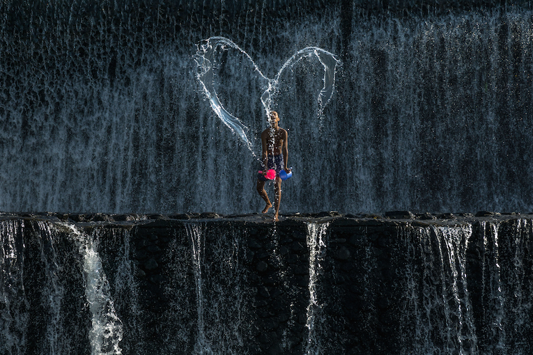 A boy creatively made a LOVE shape at the River of Tukad Yeh Unda in Klungkung Sub-District, Klungkung Regency, Bali, Indonesia.