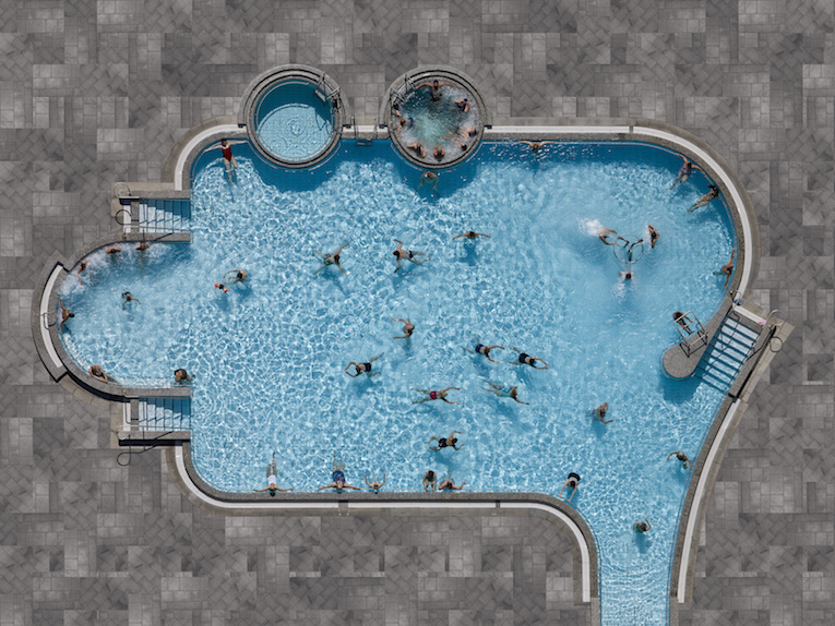 The Pools series is a study of water, one of the most precious resources for life on our planet. The artistic approach of photographer Stephan Zirwes is to show how the important resource is in contrast between being the consummate location for entertainment and the incredible waste of drinking water “not only for being used in private pools but also the trend to privatise what is a public asset and use it for commercial reasons. Public pools can still be a symbol for the importance that water should be free accessible to everyone. The clean formal language and the simple design of the pictures focus our interest on this newsworthy issue with elegance and almost playful. A deep dive into the blue as Zirwes copied parts of the original pool tiles and enlarged them in a simple, visible way to create a kind of mount in patterns.