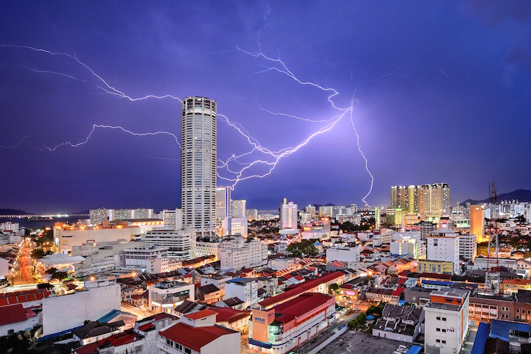 Lightning seemingly strikes Komtar Tower, the most iconic landmark of George Town, capital of Penang state in Malaysia. It is symbolic of the rejuvenation that the city, famous for a unique blend of centuries-old buildings and modern structures, has enjoyed in recent years. While many of its old neighbourhoods fell into neglect in the 1990s and early 2000s, UNESCO World Heritage listing in 2008 sparked a transformation, and today, they are all part of a vibrant tourist destination.